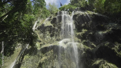 Tilt up slow reveal of Tumalog Falls in Philippines. photo