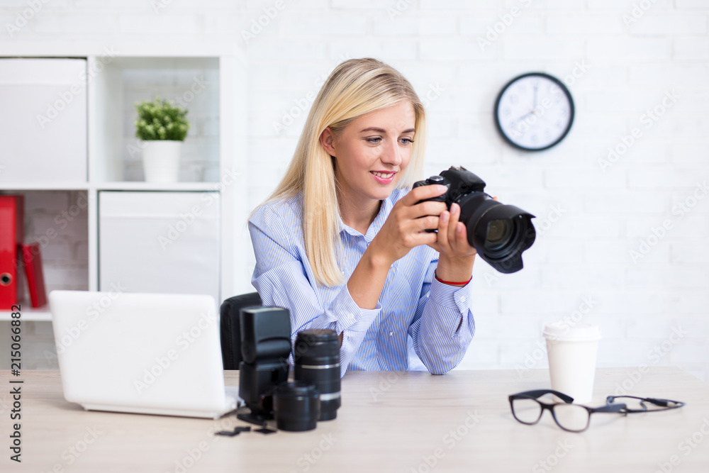 woman photographer sitting with computer and photography equipment and choosing best photos in modern office woman photographer sitting with computer and photography equipment and choosing best photos in modern office