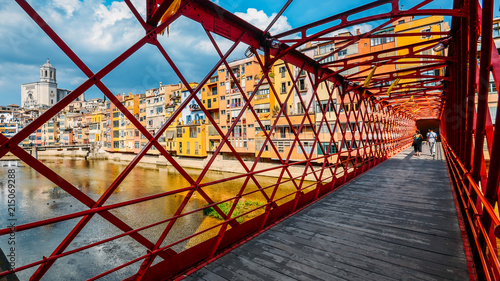 Colorful houses seen through the red iron bridge in Girona, Catalonia, Spain