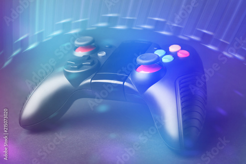 Video game controller on dark background, colorful effect. Leisure and entertainment