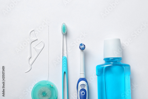 Fototapeta Naklejka Na Ścianę i Meble -  Flat lay composition with toothbrushes and oral hygiene products on white background