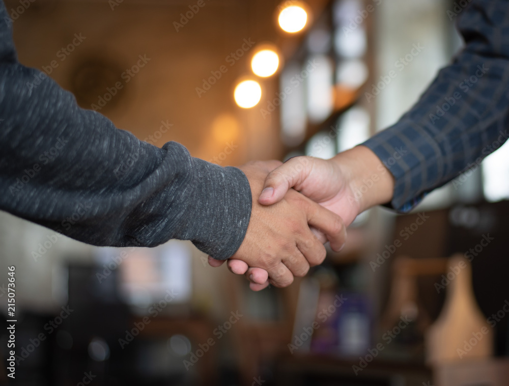 Two men shaking hands after meeting and exchanging ideas and finding mutual agreement . Successful dealing and greeting in partner concept Two men shaking hands after meeting and exchanging ideas and finding mutual agreement . Successful dealing and greeting in partner concept