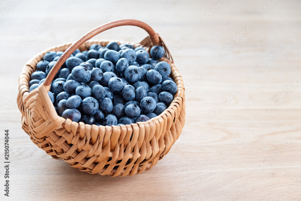 Blueberry in basket on wooden table background. Ripe and juicy fresh picked blueberries closeup Blueberry in basket on wooden table background. Ripe and juicy fresh picked blueberries closeup
