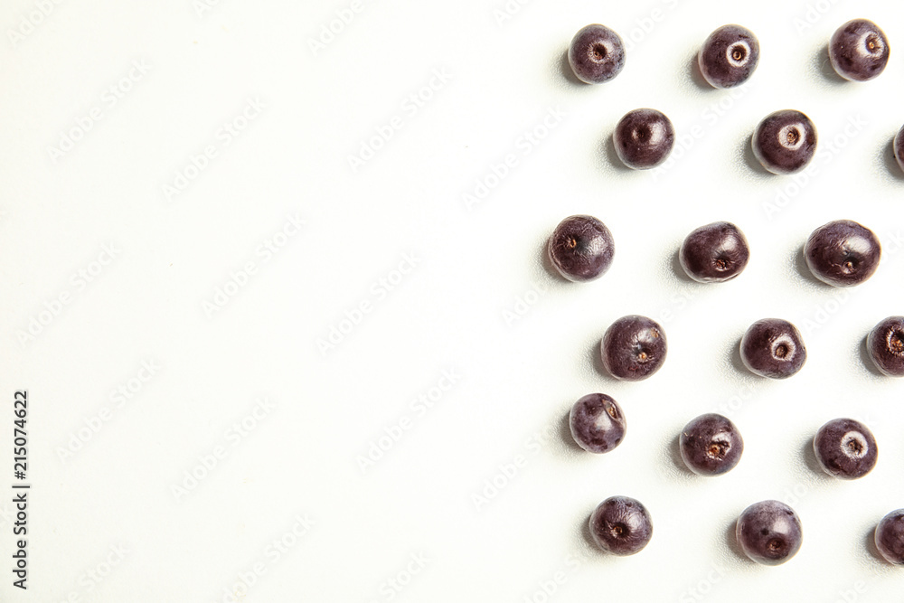 Fresh acai berries on white background