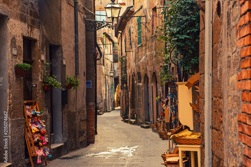 Fototapeta Naklejka Na Ścianę i Meble -  Narrow street of medieval ancient tuff city Pitigliano, travel Italy background