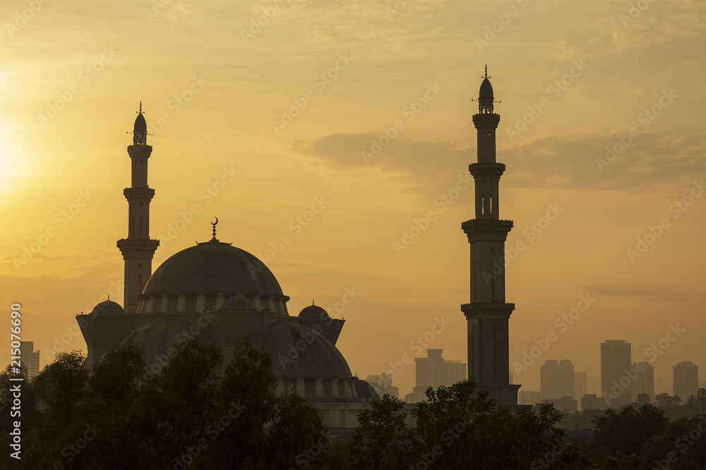Federal Territory Mosque in silhouette during sunrise