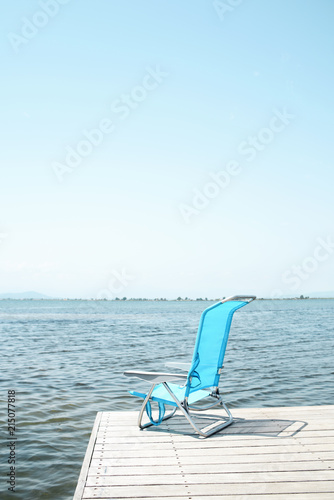 blue deck chair on a pier © nito