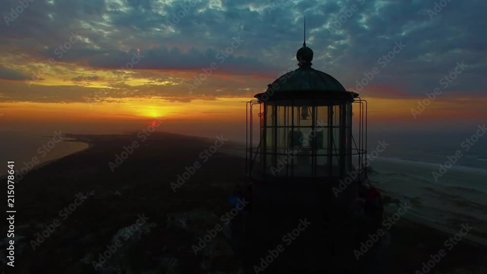 Sunrise at the shore with a Lighthouse as seen by a Drone in 4K Sunrise at the shore with a Lighthouse as seen by a Drone in 4K