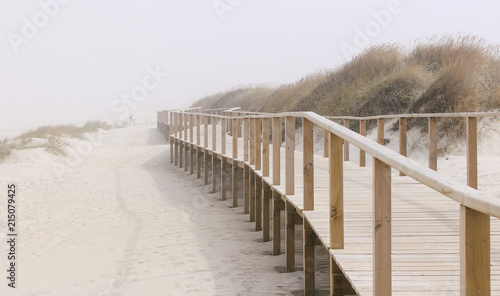Foggy photo of wooden footbridge of Costa Nova beach in Aveiro, Portugal © Ana Fidalgo