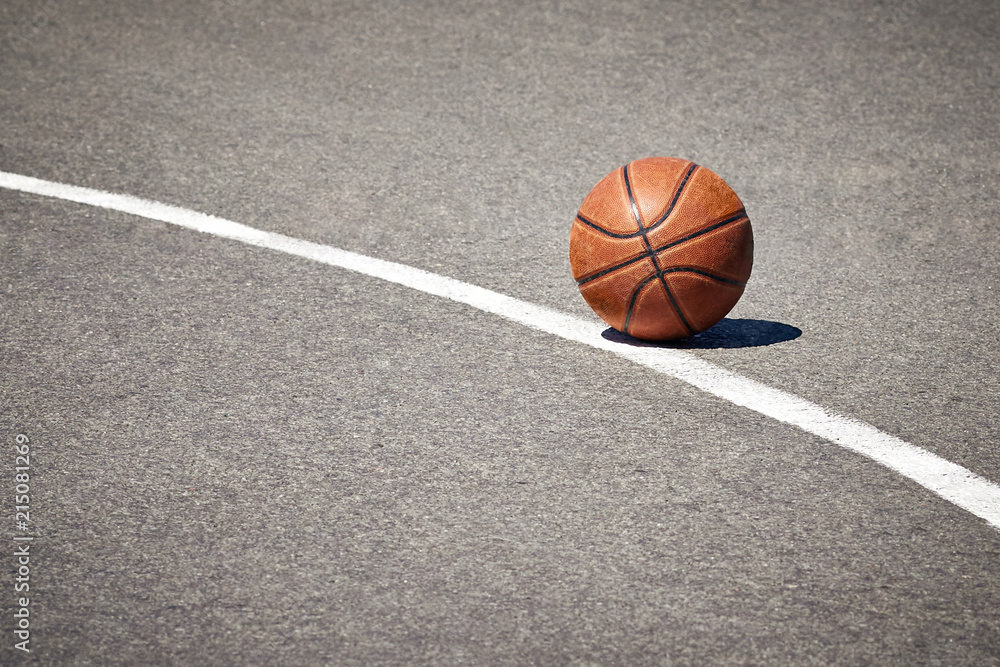 The basketball on the pavement The basketball on the pavement