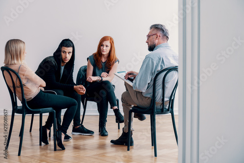 Teenagers on a group therapy with a psychiatrist