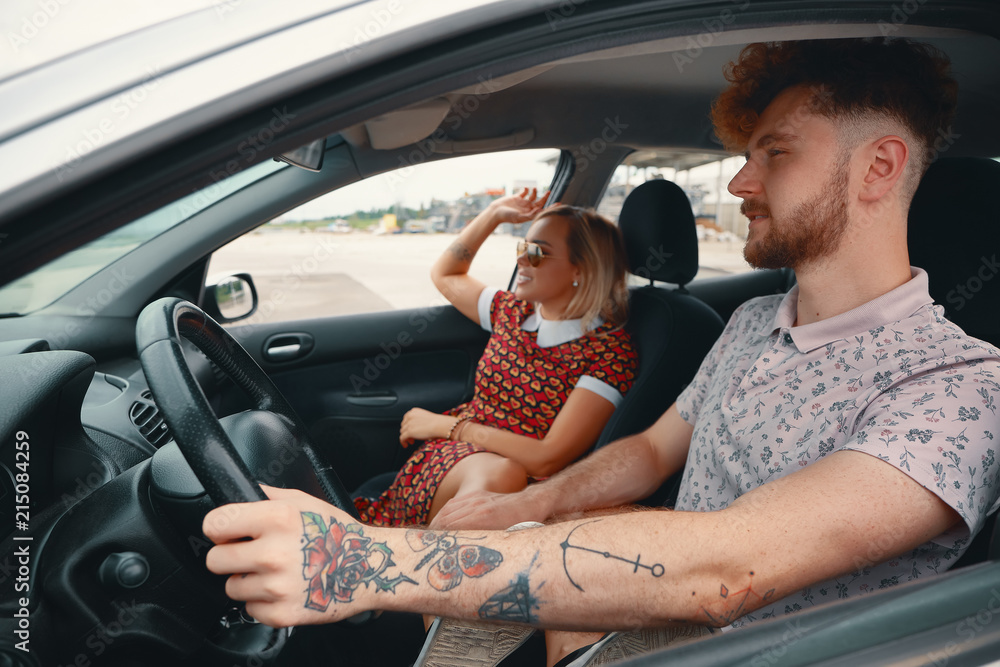 Happy couple enjoying communication while driving Happy couple enjoying communication while driving