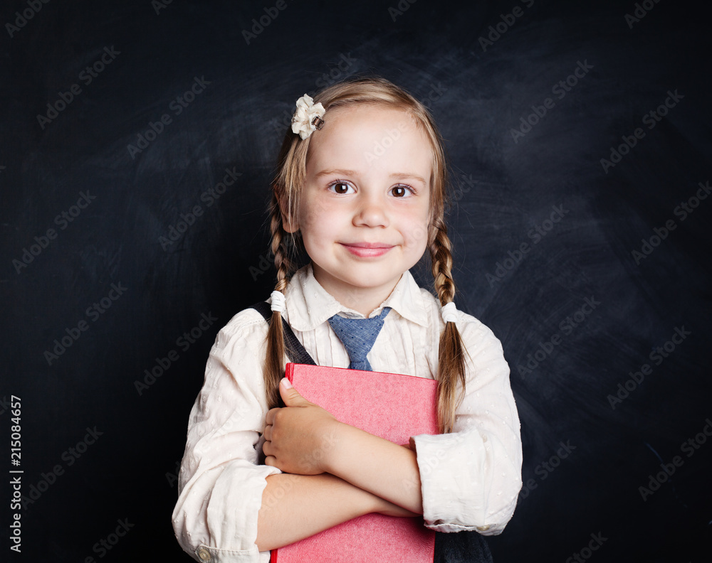 Smiling child with book. Little girl in school uniform portrait. Back to school, reading and education concept Smiling child with book. Little girl in school uniform portrait. Back to school, reading and education concept