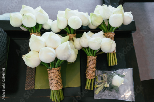 Beautiful bouquet with white roses and lotuses for the bride and bridesmaids photo