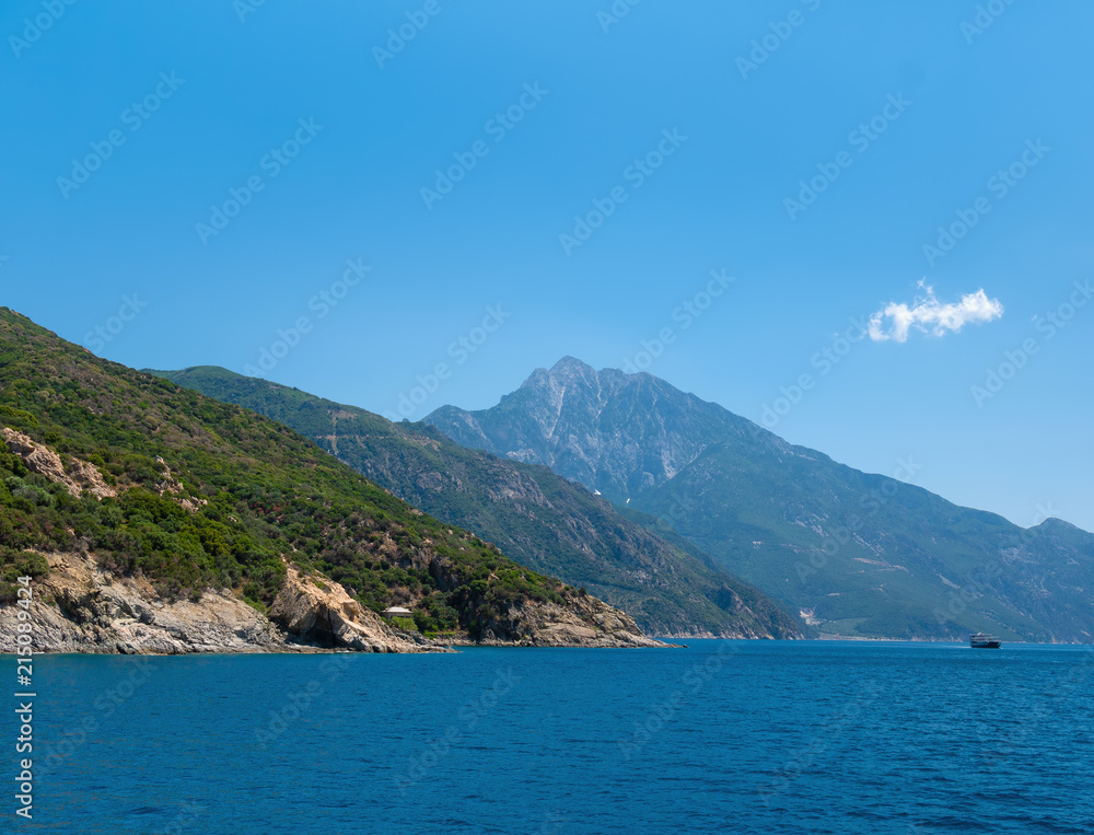 Ship sailing across the Aegean Sea near mountain of Athos