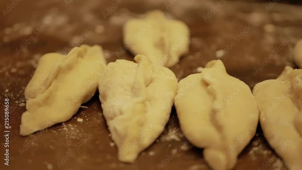Making piroshki, a Russian traditional recipe, stuffed with eggs, onion and rice. Making piroshki, a Russian traditional recipe, stuffed with eggs, onion and rice.