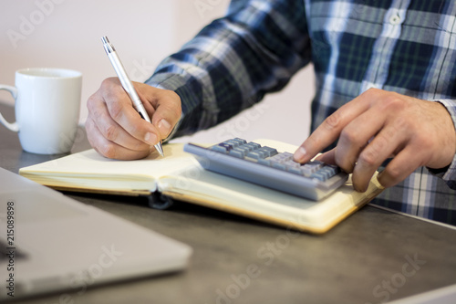 Close up of male accountant or banker making calculations