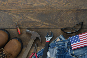 Table top view aerial image of decoration the sign of USA labor day on Sep 3,2018 background concept. Flat lay accessories tools and clothing  for worker on modern rustic brown wooden with copy space.