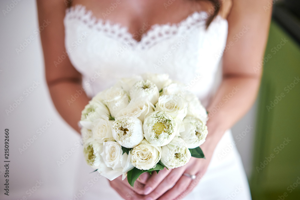 Bride holding white cream roses and lotus bouquet flowers focus on the center of bouquet, Close-up