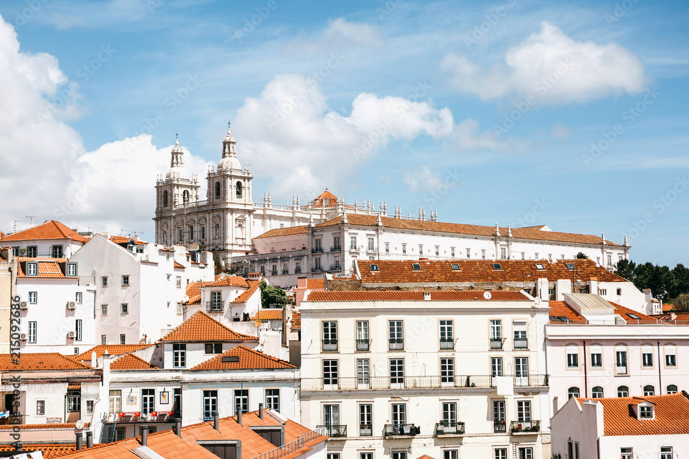Beautiful view of Lisbon in Portugal. One of the most beautiful cities in Europe. Traditional houses with yellow roofs against the blue sky.