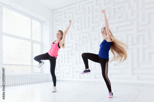 Group of two fit young women having a fitness dance class