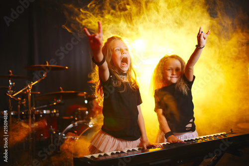Foto little girl play on synthesizer in music studio