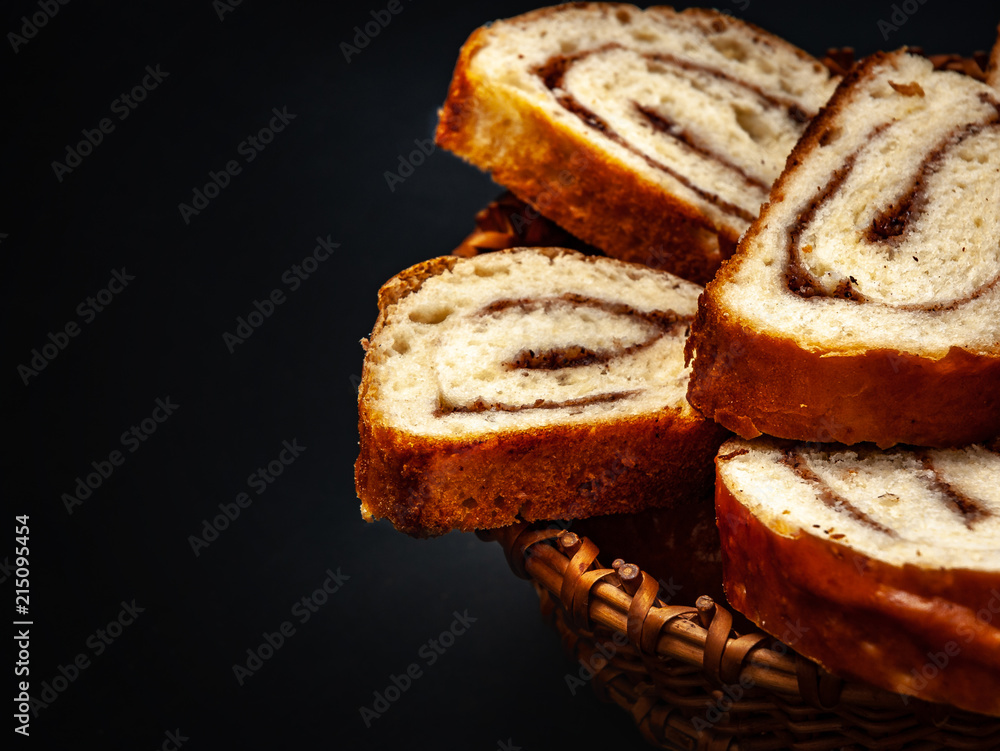 fresh appetizing strudel with cinnamon on a black background fresh appetizing strudel with cinnamon on a black background