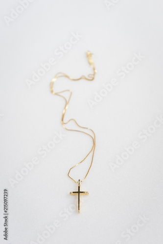 Golden cross on marble background