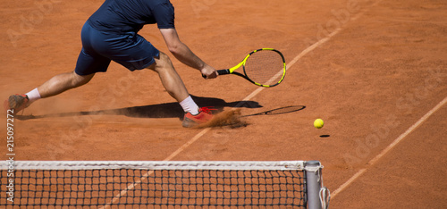 Male tennis player in action on the court on a sunny day © Augustas Cetkauskas