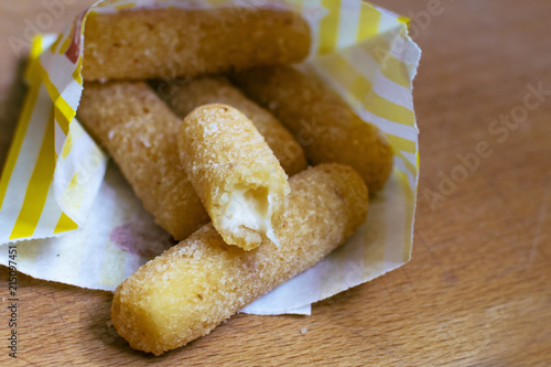 A popular light snack, cheese sticks 7.62 cm in length, are sold in packages. Cheese sticks are usually yellow, rich orange or golden in color. Produced from different types of cheese