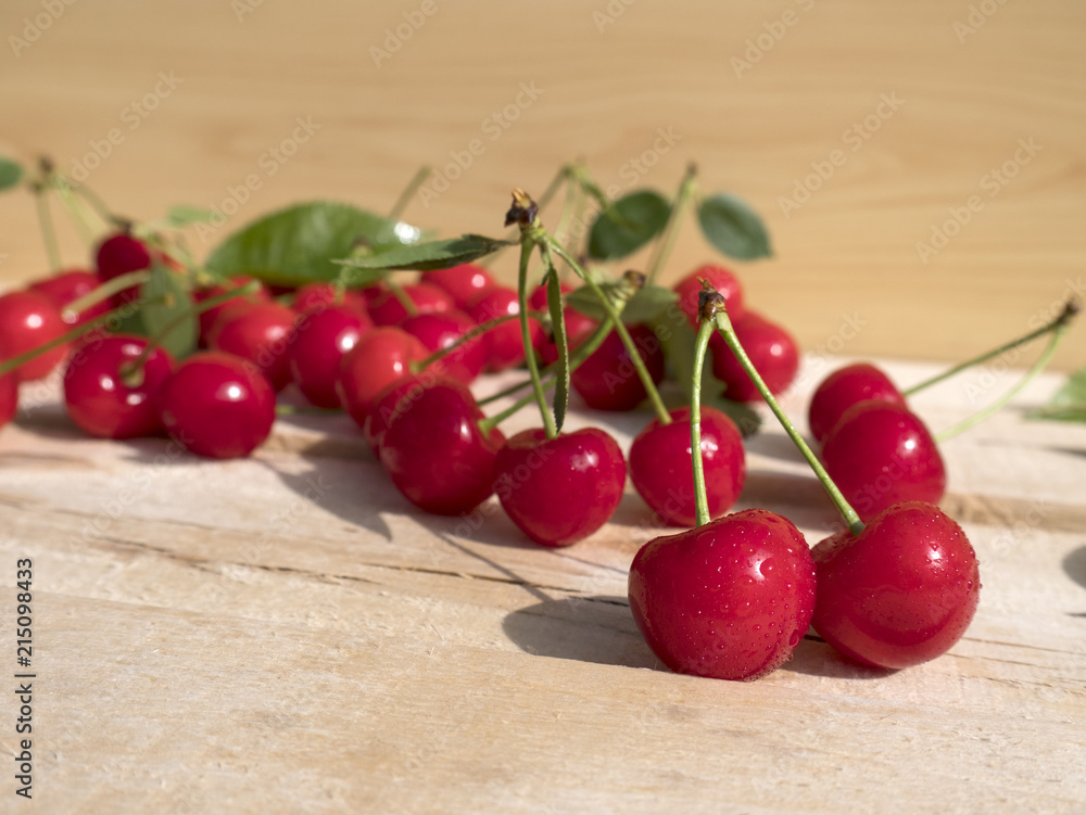 fresh cherry group with leaves on wooden table fresh cherry group with leaves on wooden table