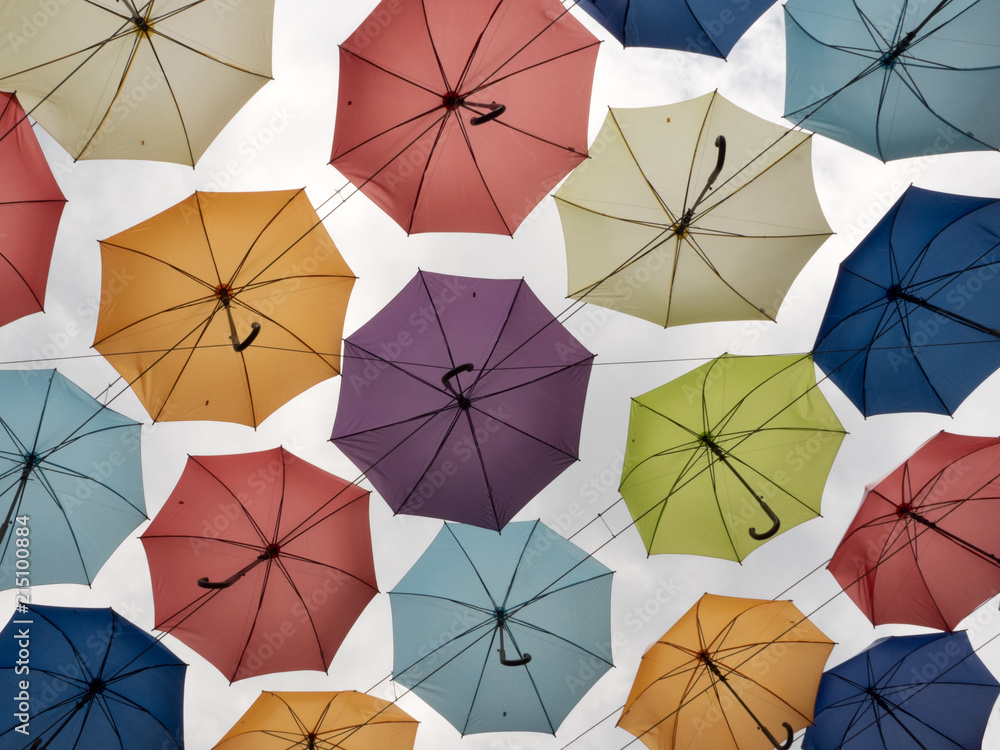 Different colors of umbrellas view from below on clear sky background Diversity concept Bright colors of the same shape objects. Colorful umbrellas on clear sky background Different colors of umbrellas view from below on clear sky background Diversity concept Bright colors of the same shape objects. Colorful umbrellas on clear sky background
