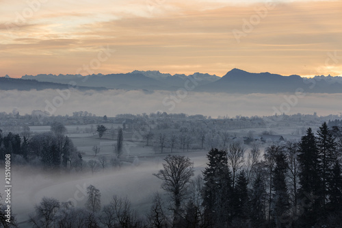 Ice cold winter morning with fog and Mount Rigi in the background at sunrise in Central Switzerland