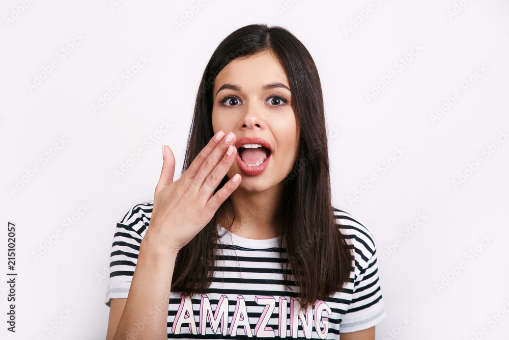 Woman with red lips and nails surprise holds cheeks by hand . Beautiful brunette girl surprised and shocked looks on you . Expressive facial expressions Woman with red lips and nails surprise holds cheeks by hand . Beautiful brunette girl surprised and shocked looks on you . Expressive facial expressions