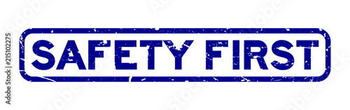 Grunge blue safety first square rubber seal stamp on white background