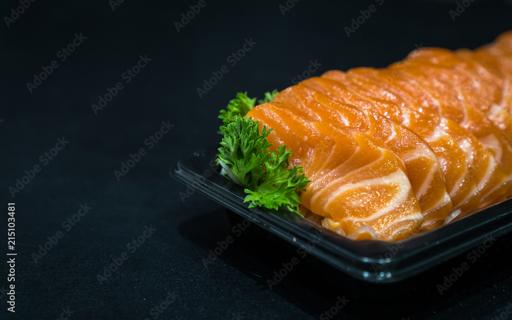 Salmon raw sashimi on black table, japanese food Closed up. Salmon raw sashimi on black table, japanese food Closed up.