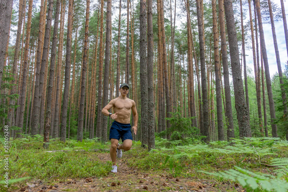 A young man is running along a flattering path A young man is running along a flattering path