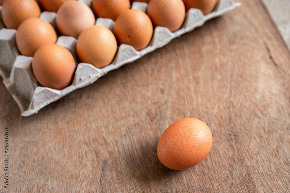 Fresh chicken eggs eggs in paper tray,egg carton on wooden background. Fresh chicken eggs eggs in paper tray,egg carton on wooden background.