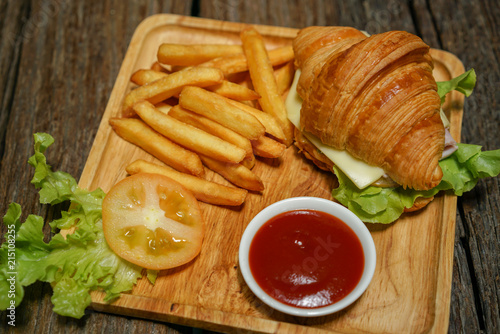 Croissant ham cheese delicious breakfast on wooden table