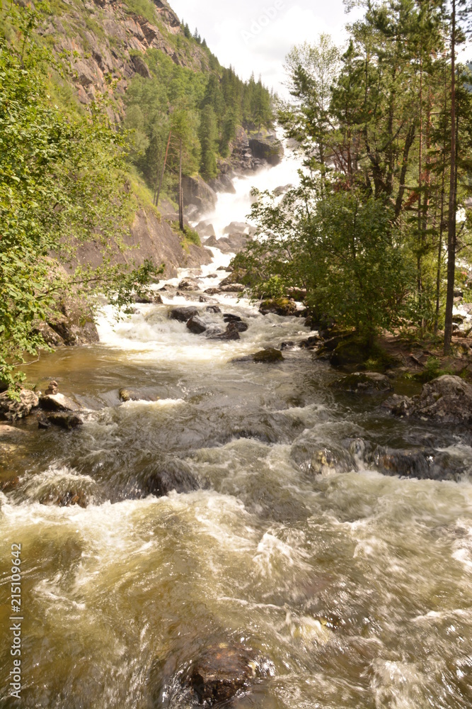 Fototapeta premium nature landscape landscape mountains valley hills rocks cave water waterfall stream river stream rock stone sky grass trees green blue white tourism excursions Russia,