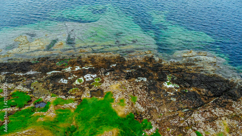 Aerial view over the green coastline and cliffs on the Isle of Skye in Scotland