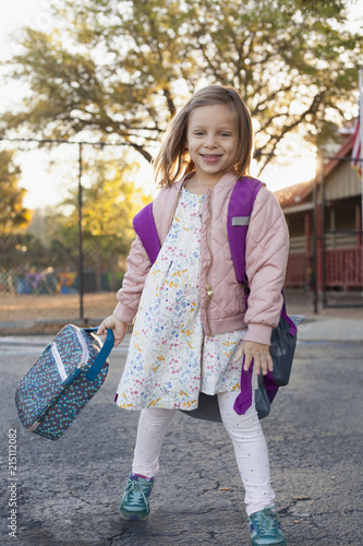 A girl standing outside building before school.