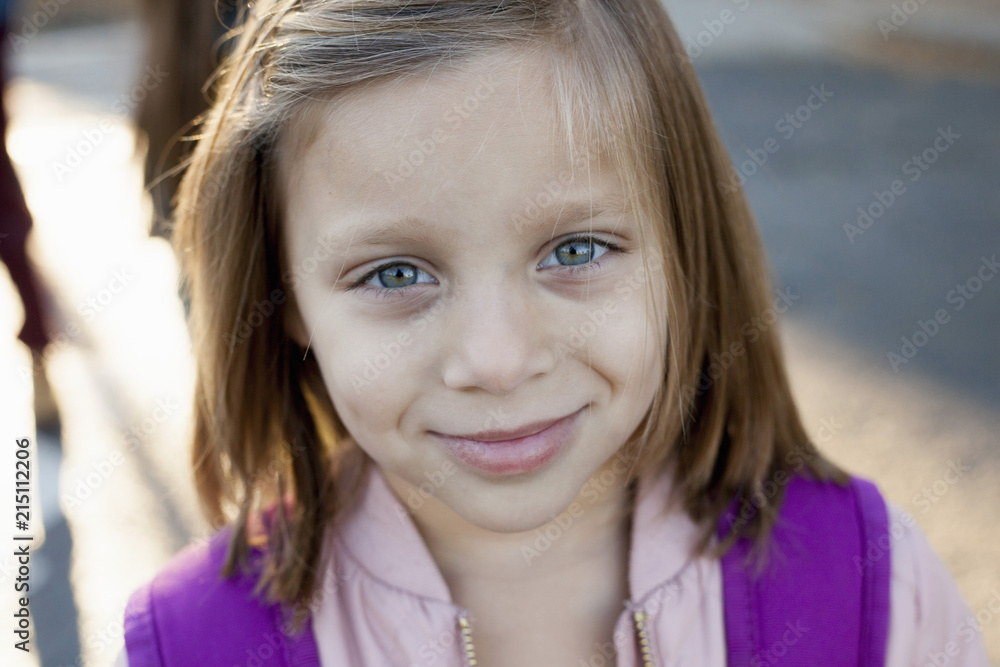 A girl standing outside building before school. A girl standing outside building before school.