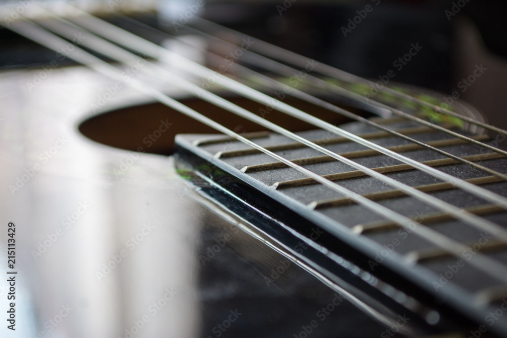 Fototapeta premium Detail of classic acoustic guitar with shallow DOF and blur.