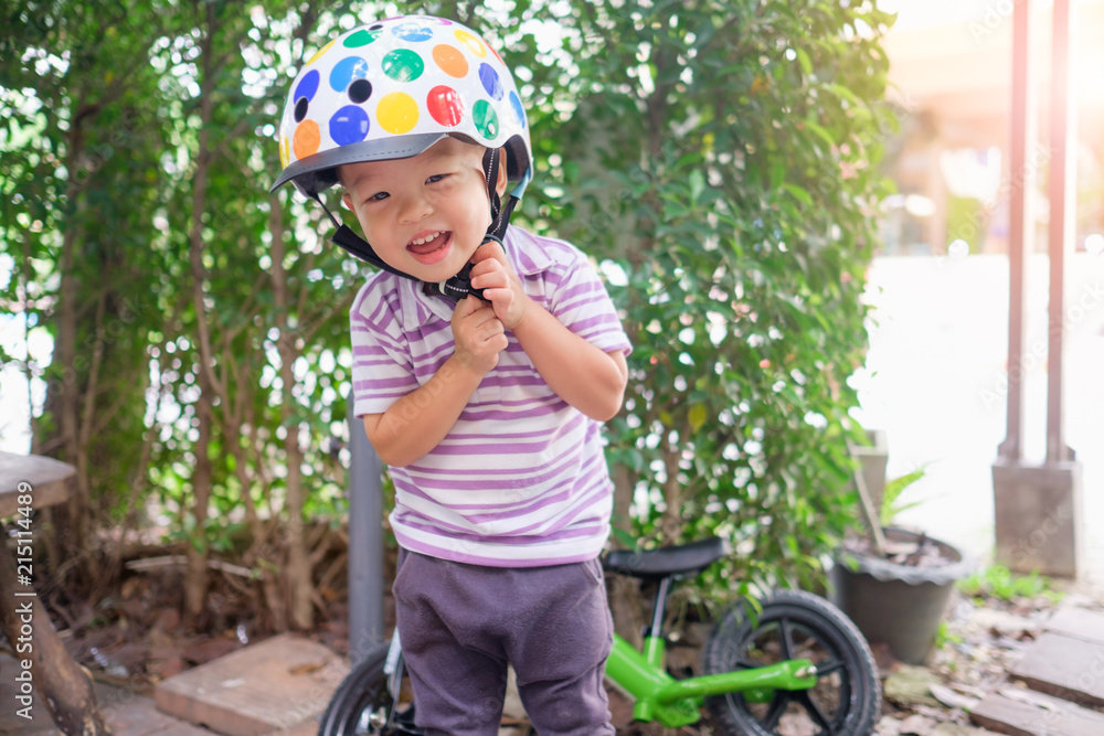 Cute little Asian 2 years old toddler boy child getting ready for