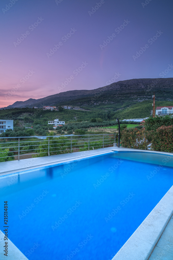 Villa with pool in mountains at sunset,long exposure
