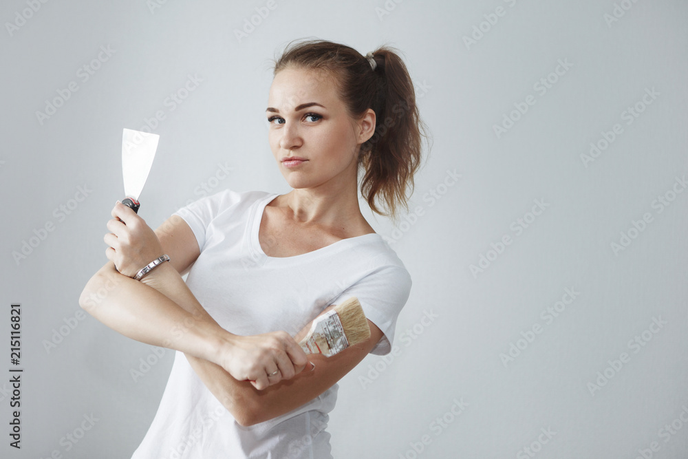 The girl is doing repairs in the apartment. The girl is doing repairs in the apartment.