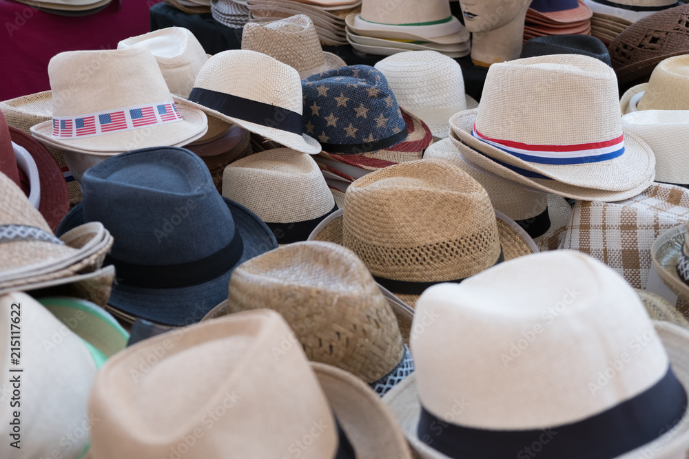 Straw hats for sale, on a market presented on a table