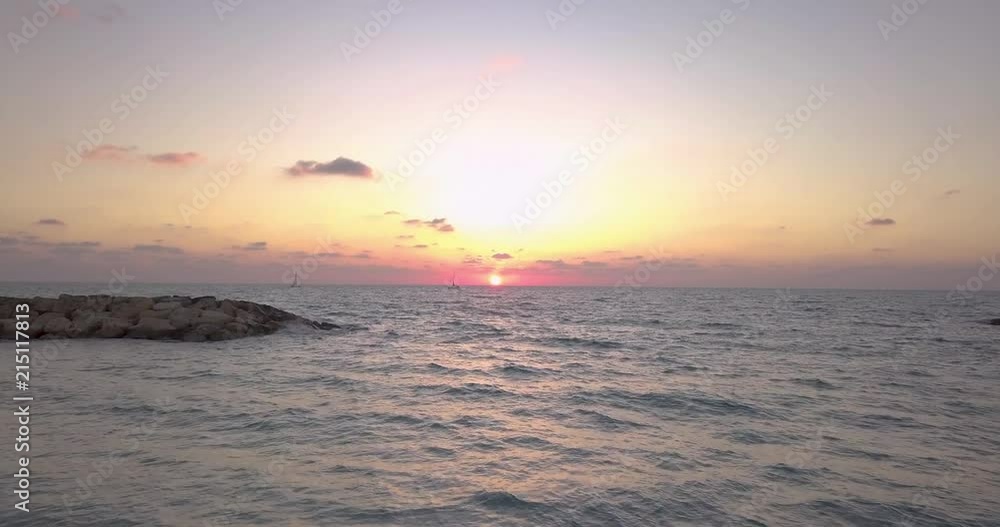 Smooth aerial shot moving forward over the Mediterranean Sea during magic hour. Slow drift towards the sunset. Smooth aerial shot moving forward over the Mediterranean Sea during magic hour. Slow drift towards the sunset.