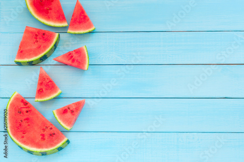 Watermelon slices on a turquoise wooden background, top view, copy space